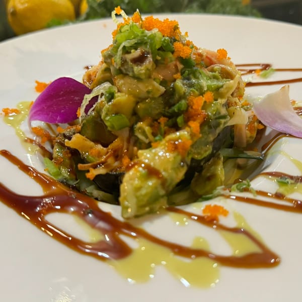 Ninja Sushi & Hibachi's avocado salad with tobiko, green onions, and purple flower garnish.